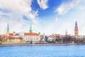 View of the Riga Castle, St. Peter`s Church and the tower of the Dome Cathedral on the banks of the Daugava River in Riga Royalty Free Stock Photo