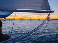 View through rigging to other yachts sailing at sunset Royalty Free Stock Photo