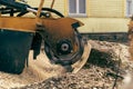 View from the right side to the stump grinder, which turns into a chip maple tree stump Royalty Free Stock Photo