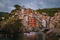 View of Riomaggiore one of Cinque Terre in the province of La Spezia, Italy, happy young couple picnic in the mountain