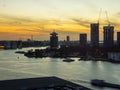 View of a river with Adam tower and modern buildings in the background during sunset, Amsterdam