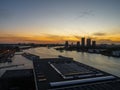 View of a river with Adam tower and modern buildings in the background during sunset, Amsterdam