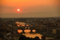 View of the River Arno and famous bridge Ponte Vecchio. Amazing evening golden hour light. Beautiful gold sunset in Florence. Royalty Free Stock Photo