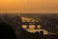 View of the River Arno and famous bridge Ponte Vecchio. Amazing evening golden hour light. Beautiful gold sunset in Florence. Royalty Free Stock Photo