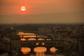 View of the River Arno and famous bridge Ponte Vecchio. Amazing evening golden hour light. Beautiful gold sunset in Florence. Royalty Free Stock Photo