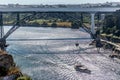 View of the river Douro and the bridges D. Maria Pia and the Infante, banks and boats sailing on the river