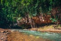 View on the river flowing in to the big rock cave