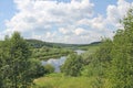 View of the river, forest and green meadows. White clouds in the Royalty Free Stock Photo