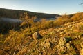 View of river Litava valley near ruins of Cabrad castle during autumn sunrise with fall coloured trees
