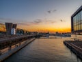 View of a river and modern buildings during scenic sunset, Amsterdam