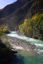 View of the river in the mountains in the middle of autumn trees. Autumn high in the mountains, autumn Royalty Free Stock Photo