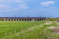 A view beside the River Nene as a train croses the Irchester viaduct near Wellingborough UK
