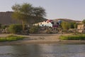 View of river nile in Aswan Egypt with Nubian house on riverbank