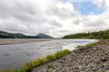 A view of River Pattack flowing to the head of Loch Laggan and Scottish highlands on the background, Cairngorms National park, Sco