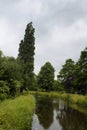 View of a river, plants and trees in Volendam.