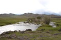 View of a river sorrounded by a green landscape in central Mongolia