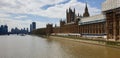 View of the river Thames in London with parts of the House of Parliament being renovated against blue sky and clouds Royalty Free Stock Photo