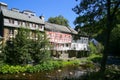 View on river with timber frame monument houses in center of medieval village