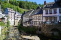 View on river with timber frame monument houses in center of medieval village
