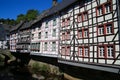 View on river with timber frame monument houses in center of medieval village