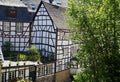 View on river with timber frame monument houses in center of medieval village