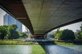 View of the river under the bridge. View of the bridge from below the river on a Sunny summer day Royalty Free Stock Photo