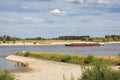 View on the river Waal and the Millingerwaard, near Nijmegen, the Netherlands with vessel and equus caballus caballus