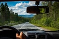 View of the road through the front window of the car