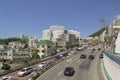 View on the road with moving cars and cityscape on sunny day