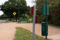 View of a road by the park with roadsigns and a bench