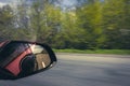 View of the road through the side rearview mirror Royalty Free Stock Photo