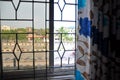 View of the road through the window and curtains on a sunny day