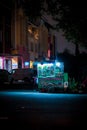 view of roadside food vendors that are still open at night