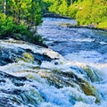 Roaring water cascade on a river bend Royalty Free Stock Photo