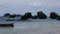 The view of the rock at sea against the sky.