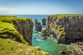 A view of rock stacks offshore from the top of a secluded cove along the Pembrokeshire coast, Wales Royalty Free Stock Photo