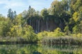 Waterfalls from rock surrounded by a forest at plitvice lakes