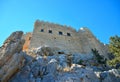 View of a rock wall with walls and a medieval castle Royalty Free Stock Photo