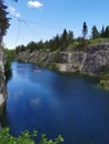 View of the rocks and the emerald water of the Marble Canyon in the Ruskeala Mountain Park, which reflects the sky and clouds on a Royalty Free Stock Photo