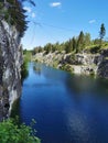 View of the rocks and the emerald water of the Marble Canyon in the Ruskeala Mountain Park, which reflects the sky and trees on a Royalty Free Stock Photo