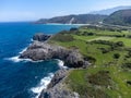 View on rocks on Playa de Toro in Llanes, Green coast of Asturias, North Spain with sandy beaches, cliffs, hidden caves, forests