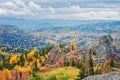 View of the rocks under the clouds, mountainous colorful taiga with autumn withered grass high in the mountains Royalty Free Stock Photo