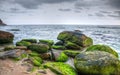 View of a rocky bay with dramatic cloudscape