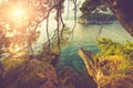 View from a rocky cliff into the sea and beach at sunset. Milocer Park. Coast Budva Riviera. Montenegro.