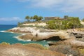 View of the rocky coast and the famous Casa del Duque on cliff in Playa del Duque area in popular resort in southern coast of