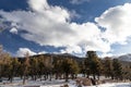 View of the Rocky Mountains at Pikes Peak, snow covered winter landscape under a blue sky with bright white clouds Royalty Free Stock Photo