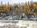 View of the rocky shore of the wild rapid Siberian river in autumn
