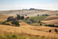 view of rolling hills with farmhouses and crops in the distance