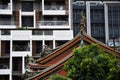 View of a roof of a historic temple in front of a modern building in Taipei, Taiwan Royalty Free Stock Photo