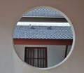 View of roof and pigeon through round window Royalty Free Stock Photo